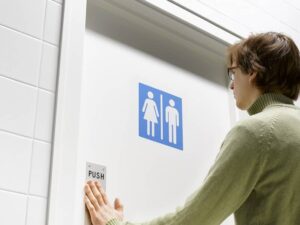 Man pushing toilet door-cm