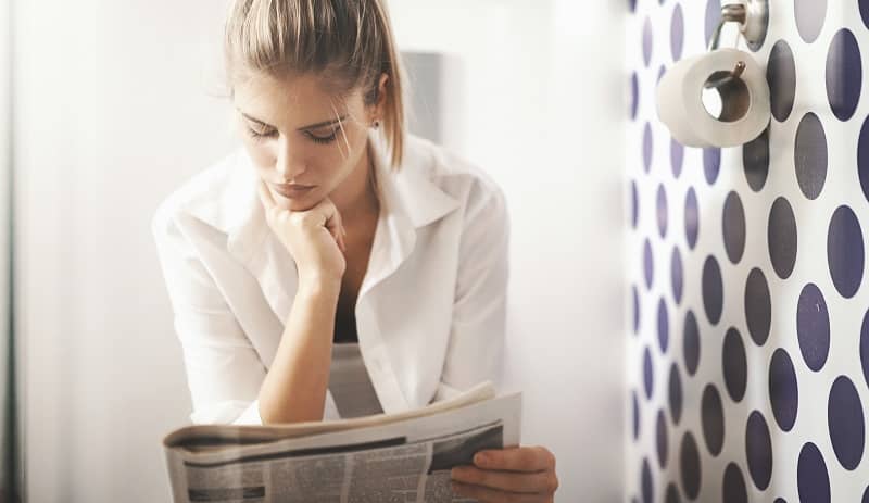 Reading newspapers in toilet.-cm